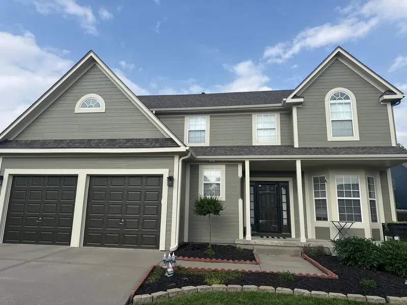 After: Two-story: buttery yellow to sage green with cream trim