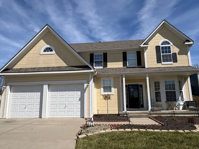 Before: Two-story: buttery yellow to sage green with cream trim