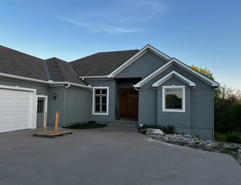 Gray stucco ranch home painted in fall