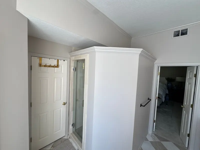 Freshly painted bathroom and hallway with crisp white trim