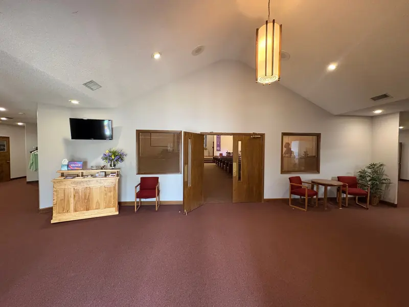 Bright white church lobby with vaulted walls