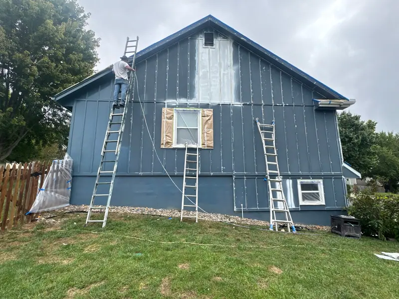 Repairs and painting underway on a blue home