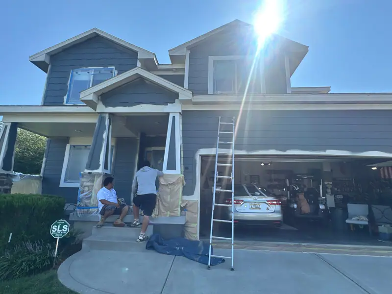 Crew painting a front porch and garage
