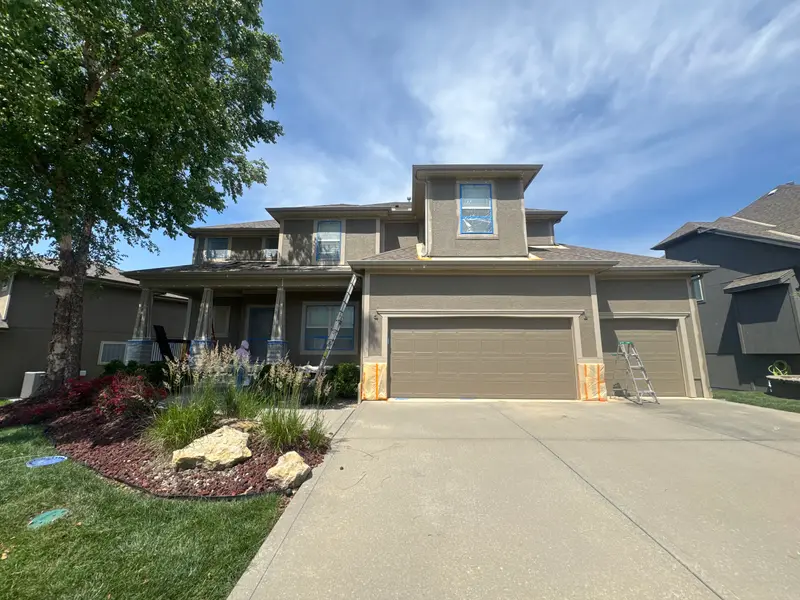 Cade pointing out trim details to a homeowner during an on-site estimate