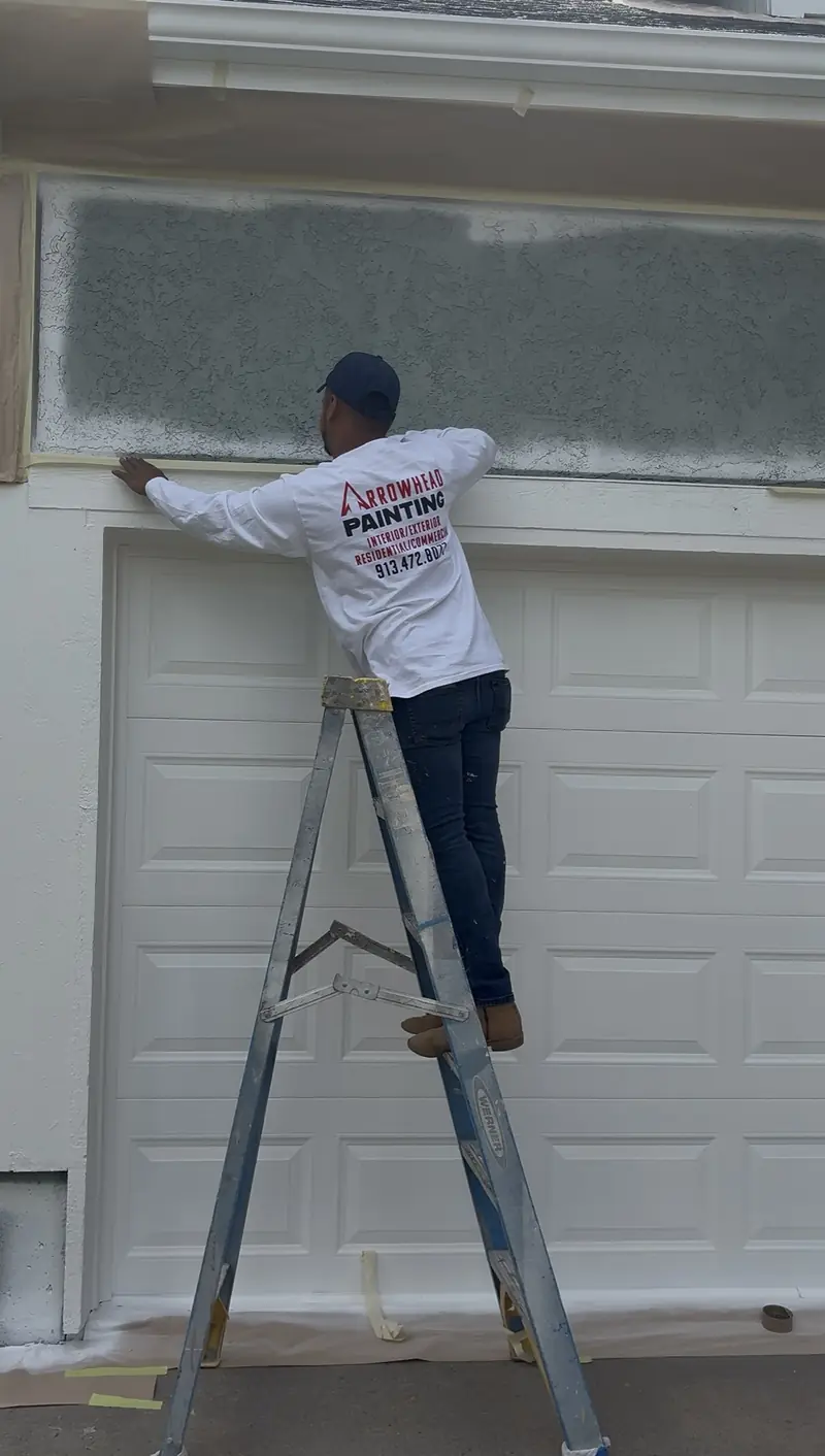 Painter finishing garage door trim