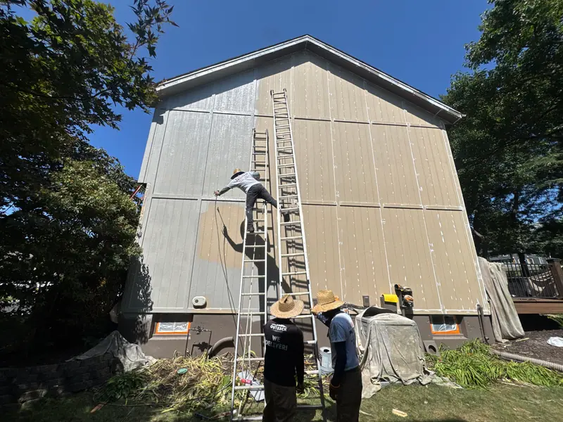 Painters working a two-story gable