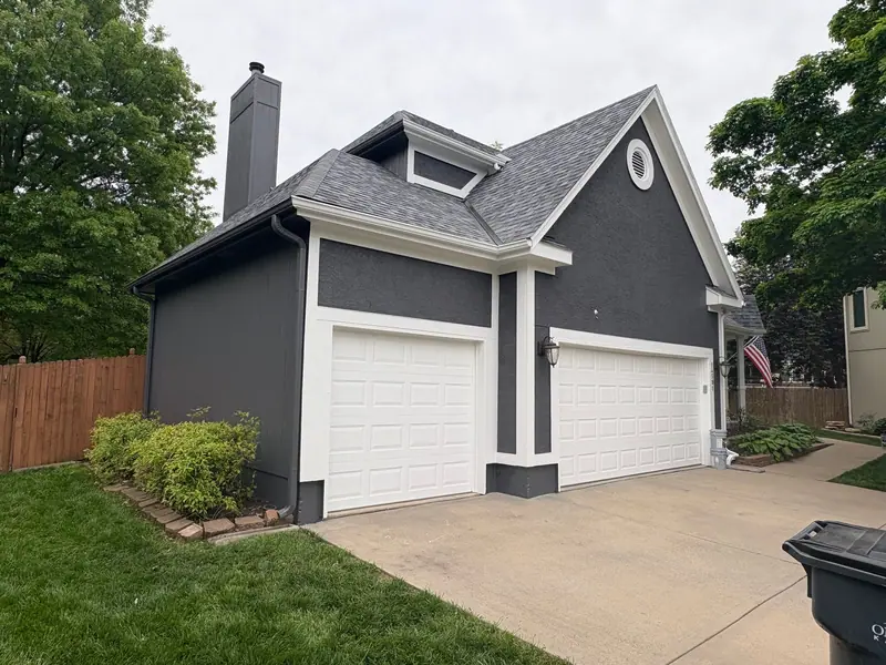 Dark gray two-story with crisp white trim