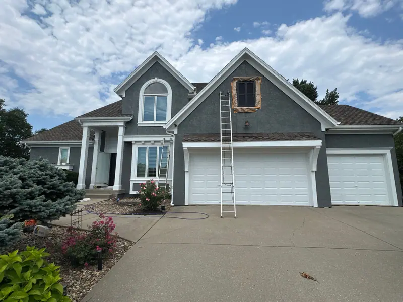 Gray two-story with a three-car garage