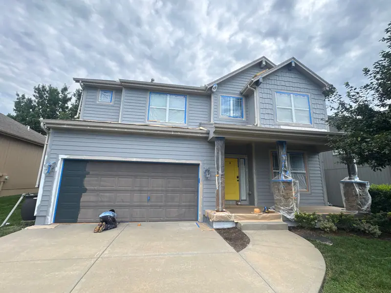 Gray two-story with a yellow front door