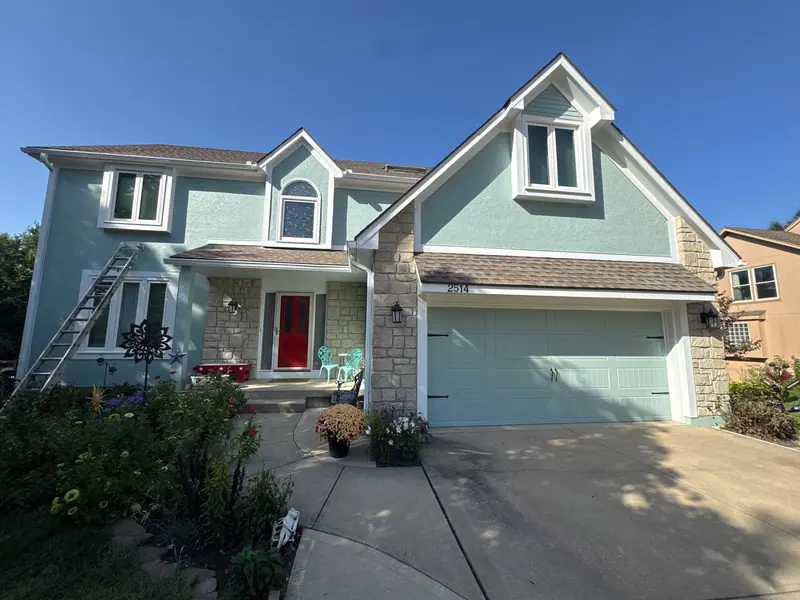 Seafoam two-story with a red front door