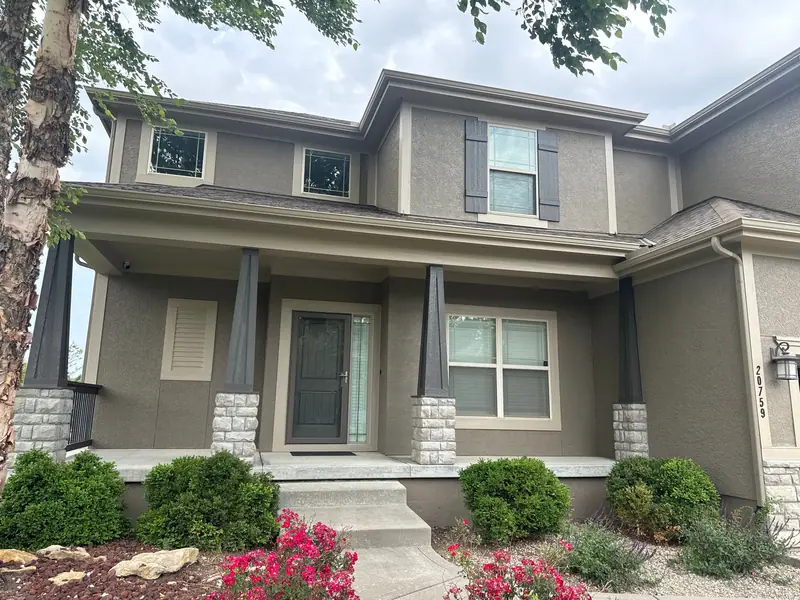 Taupe two-story with a covered porch