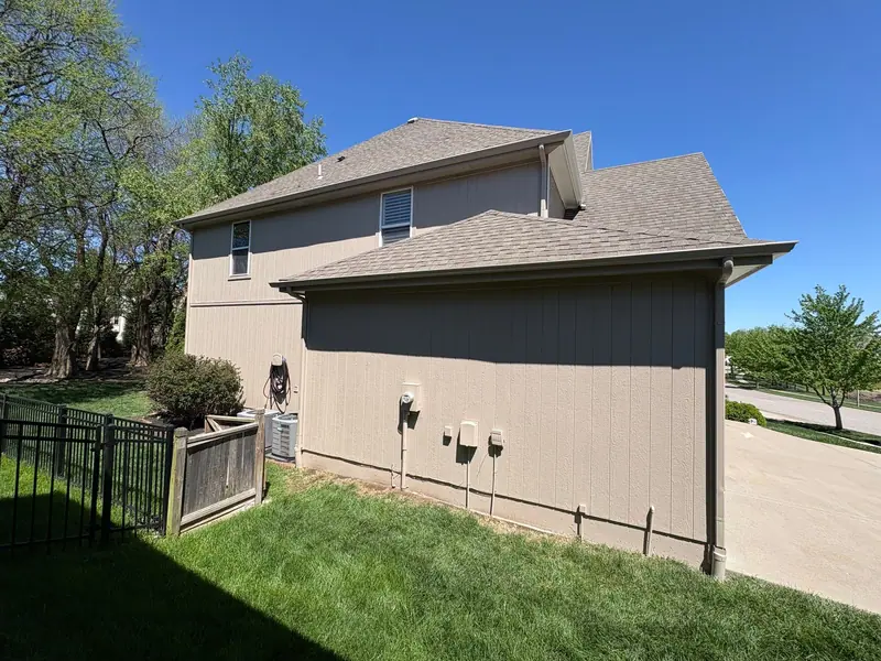 Taupe two-story after an exterior repaint
