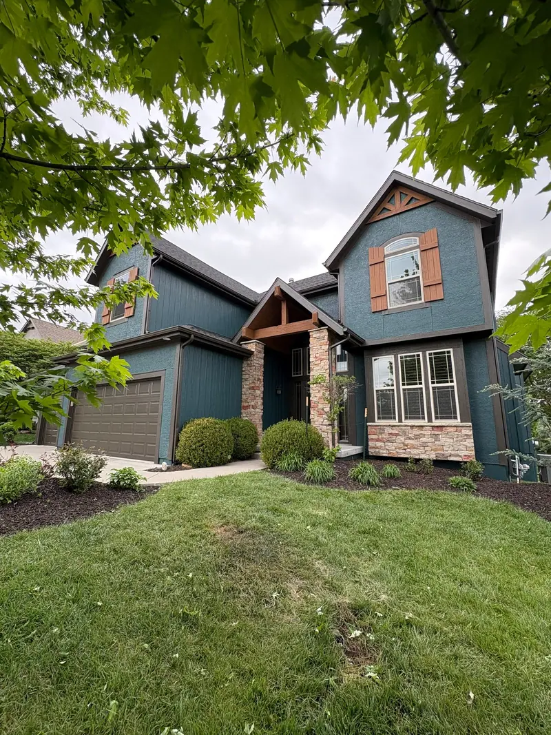 Teal two-story with cedar accents
