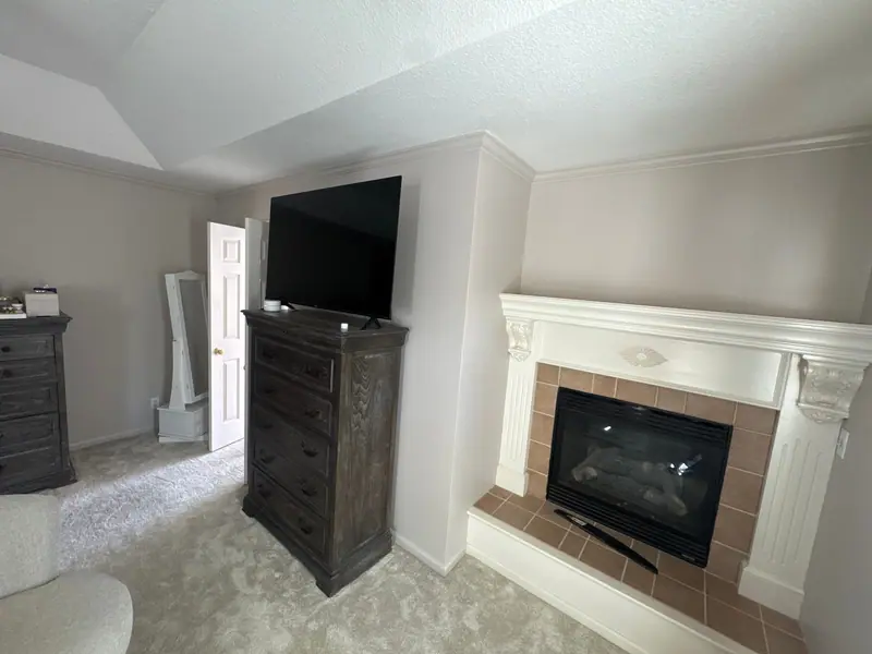 Bedroom with a freshly painted fireplace wall