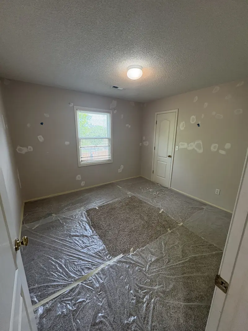 Drywall patches being prepared before painting