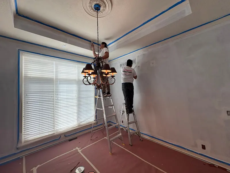 Arrowhead crew cutting in a dining room with floors protected