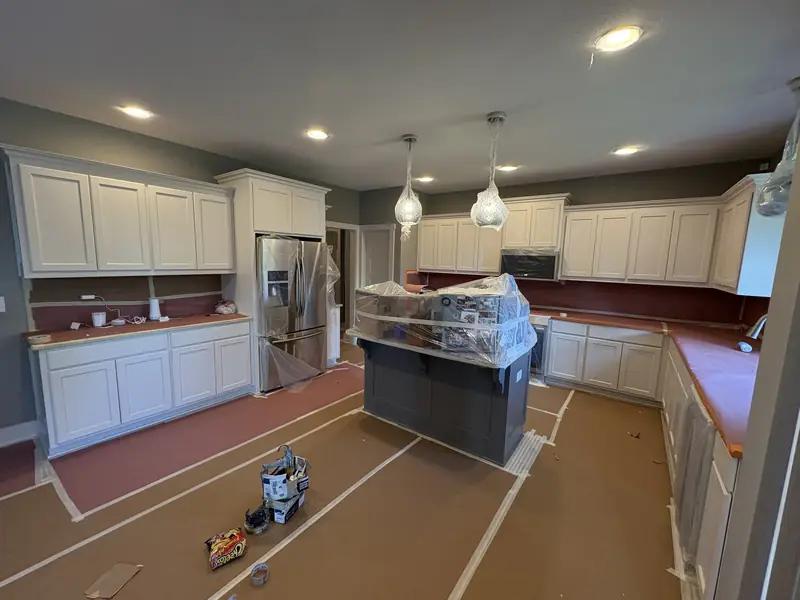 White kitchen cabinets being refinished