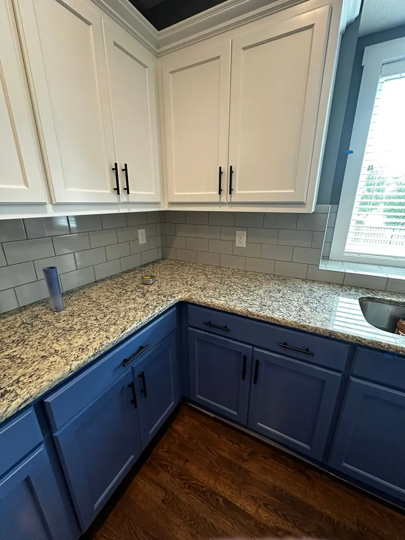 Kitchen with white upper and blue lower painted cabinets