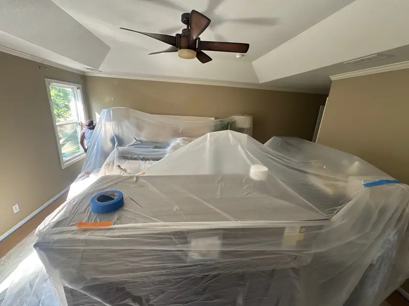 Bedroom furniture fully covered before painting