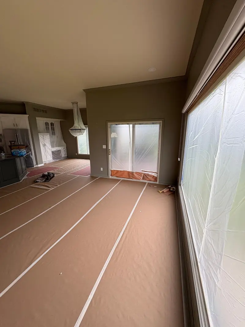 Room with floors papered and windows sheeted