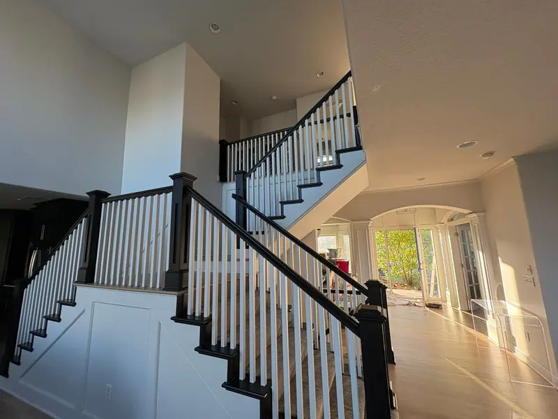Two-story staircase with black railings