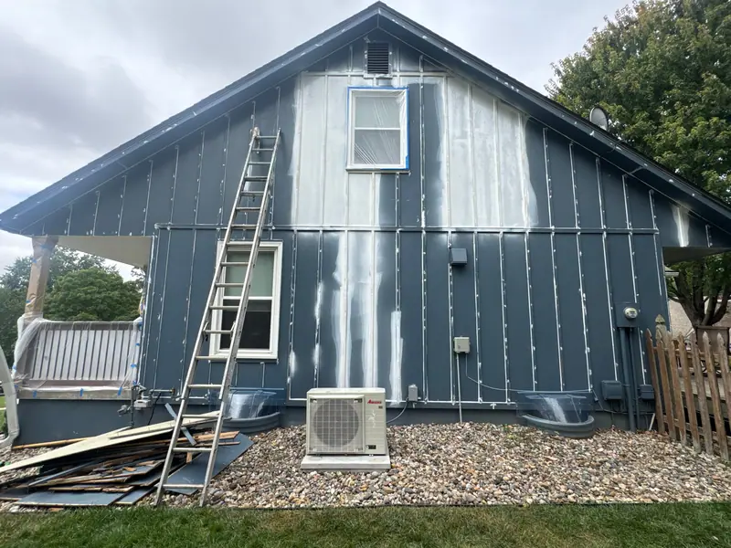 New siding boards installed on a two-story home during a repair