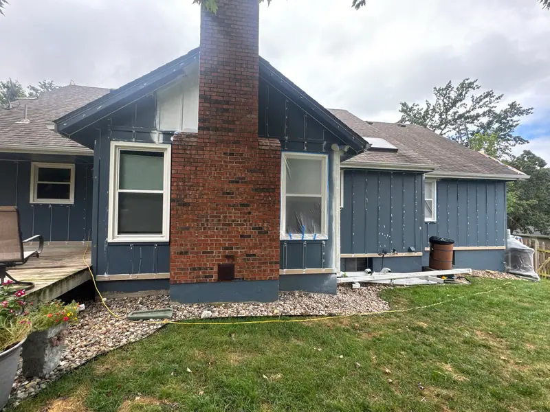 New board-and-batten siding installed before paint