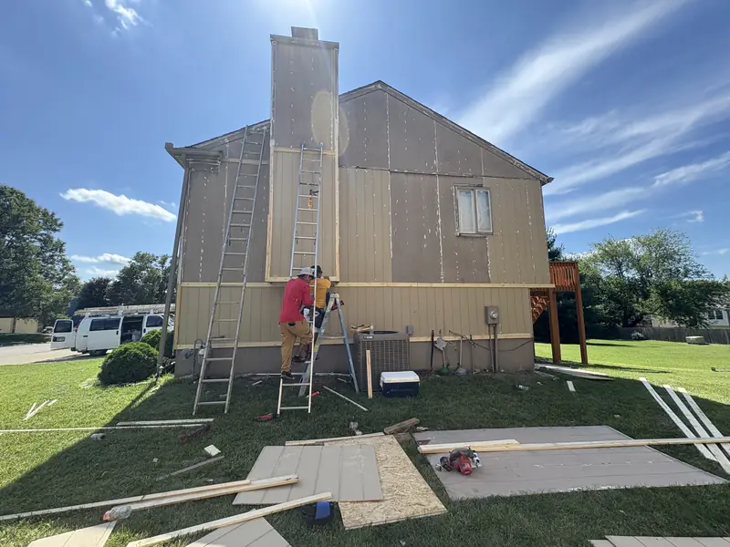 Arrowhead carpenters replacing siding panels on a chimney chase