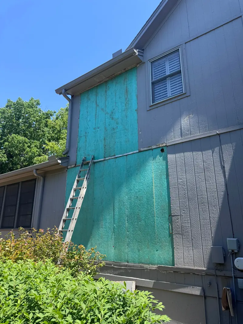 New siding panels installed across two stories during a repair