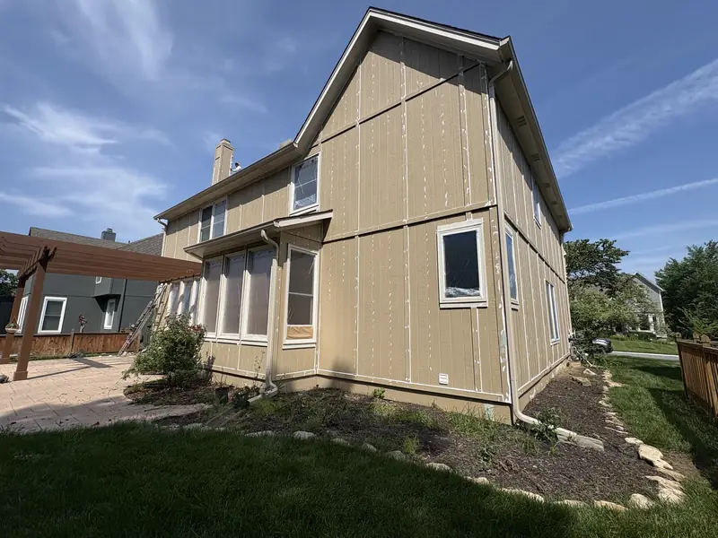 New siding installed and primed on a two-story home