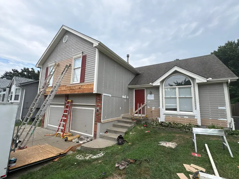 New siding and trim going in on the front of a home