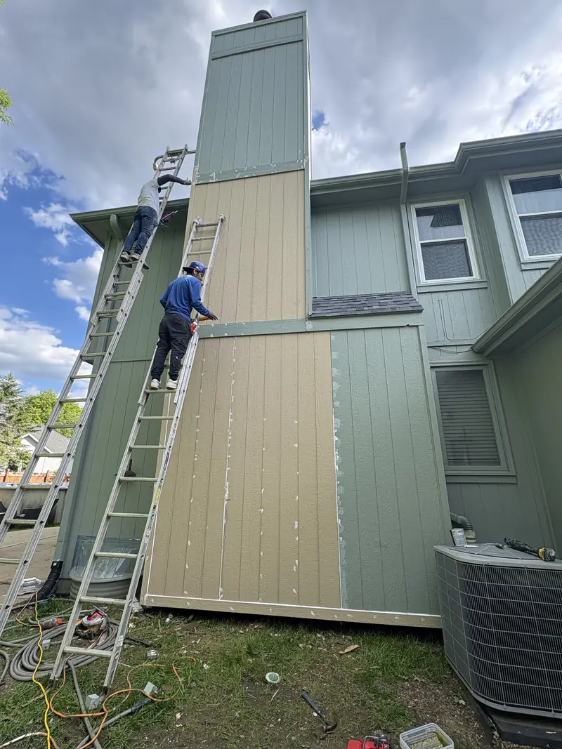 Rotted siding being replaced on a chimney chase
