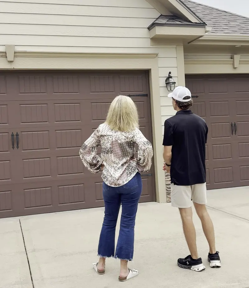 Cade pointing out trim details to a homeowner during an on-site estimate